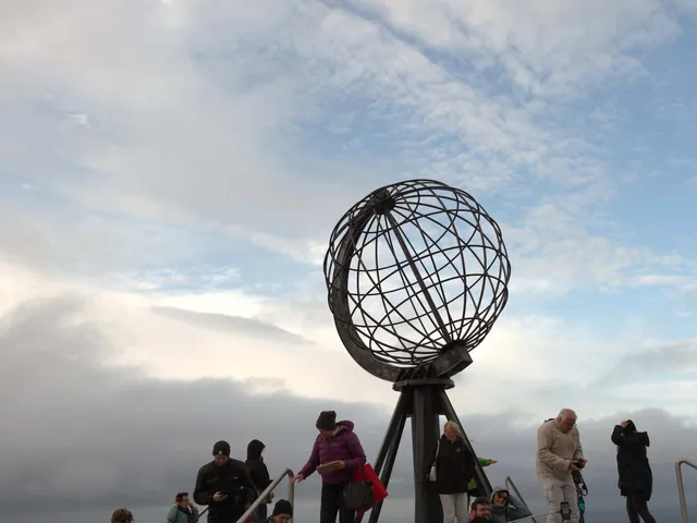 El globo metálico de Cabo Norte con gente alrededor